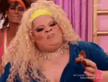 RuPaul eating a cookie