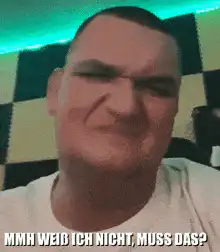 Man squinting confused face