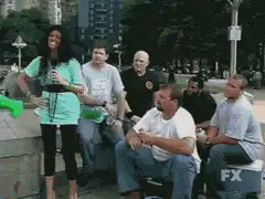 Green man throws ball at woman