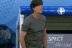 Joachim Low pulls up shirt and covers mouth