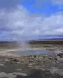 Geyser erupting in a field