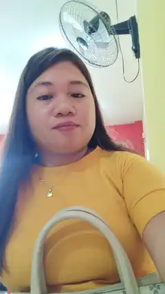 woman in yellow shirt with fan