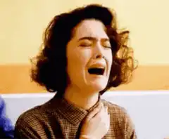 woman crying with hand on chest