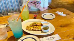 person taking photo of food and drinks at restaurant