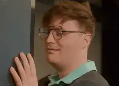 Man peeking around corner with glasses