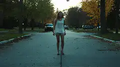 Woman walking down a suburban street