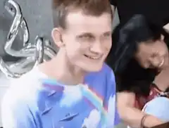 Man in rainbow shirt smiling