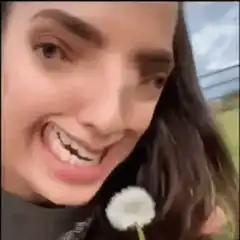 woman eating daisy flower