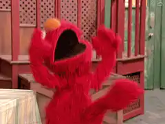 Elmo celebrating with arms raised