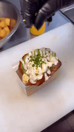 Garnishing loaded fries with chives