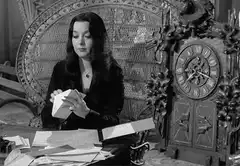 Morticia Addams ignores Thing