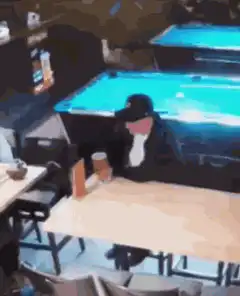 man sleeping at table in bar