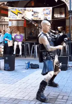 man playing bagpipes with fire