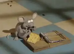 Claymation mouse eating cheese