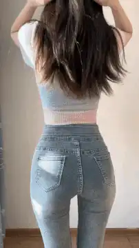 Girl in jeans and crop top turns around