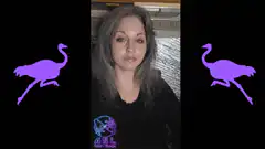 Woman making hand gestures with purple ostriches