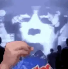 Hand opening Pringles can in front of screen