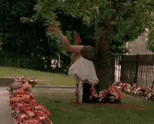 woman falls into flower bed