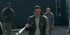 Negan walks with his bat Lucille