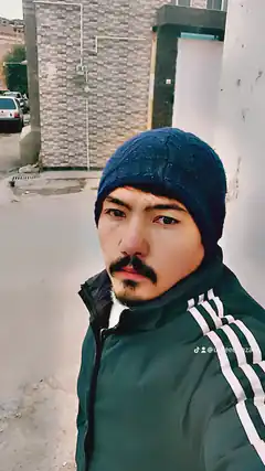 Man in beanie and green jacket