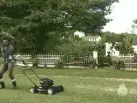 Man mowing lawn and dancing