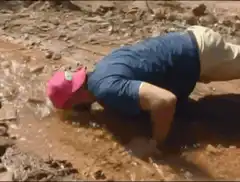 Man doing pushups in mud