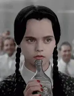 Wednesday Addams drinking poison