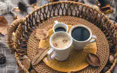Three coffee cups in a wicker basket