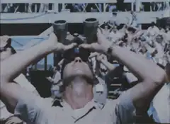 Man looking through binoculars upside down