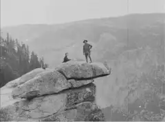 Man throws hat off cliff