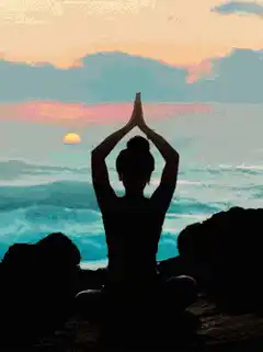 Silhouette meditating at sunset