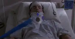 Unconscious patient in hospital bed