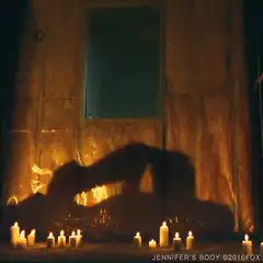Silhouette kissing in front of fire