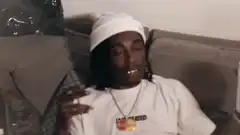 Quavo rolling eyes and drinking