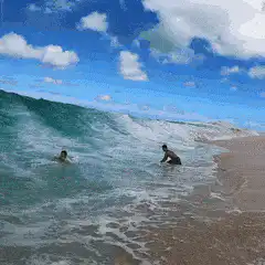 Surfer rides a wave into the camera