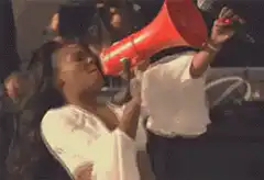 Woman shouting into red megaphone