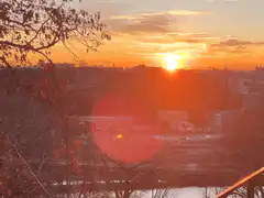 sunset over city with lens flare
