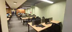 Empty office with rows of desks and computers