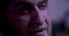 Man crying and wincing in pain