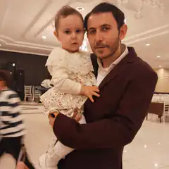 man holding baby at event