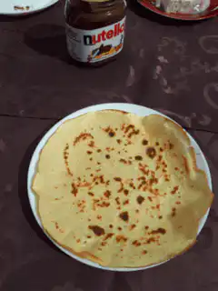 Crepe folded and eaten to reveal Nutella text