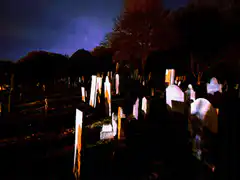 glowing tombstones in a dark cemetery