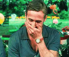 Ryan Gosling laughing and covering his face