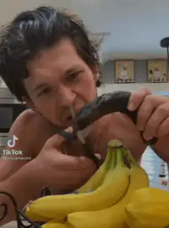 Man eating banana with cucumber skin