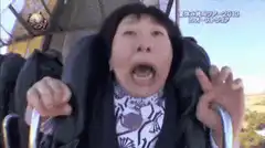 Old woman screaming on a roller coaster
