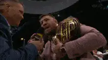 Conor McGregor holding UFC belt and microphone