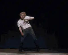 Blond man dancing on stage