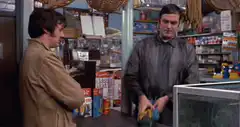Man holding a fish in a shop