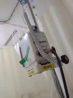 Hospital IV pole with coiled cord and labels