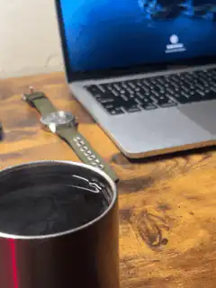 Coffee cup on desk with laptop